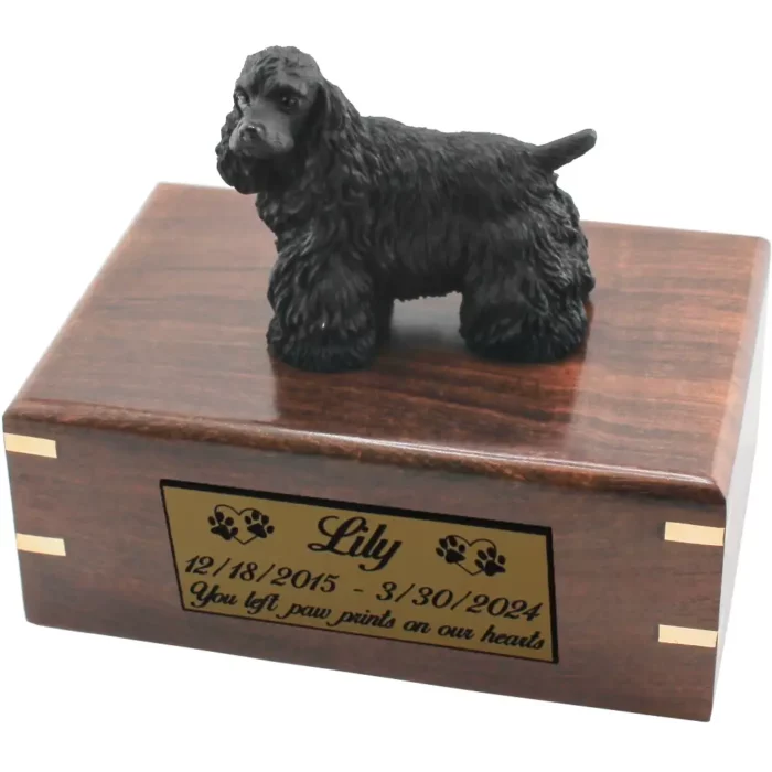 Black cocker spaniel dog figurine on wood cremation urn, engraved plate