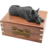 Black german shepherd figurine on wood cremation urn, with engraved plate