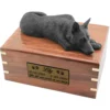Black german shepherd figurine on wood cremation urn, with engraved plate