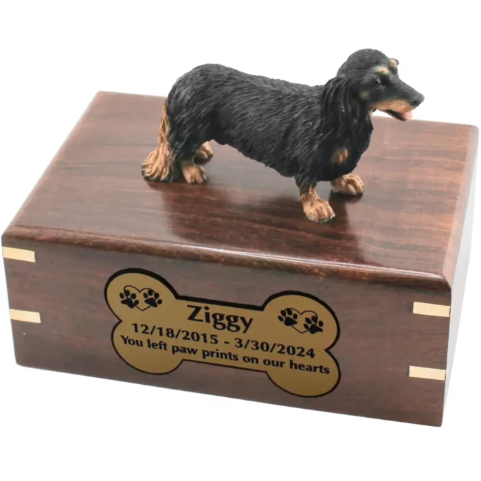 Black and tan longhaired dachshund dog figurine on wood cremation urn, engraved plate