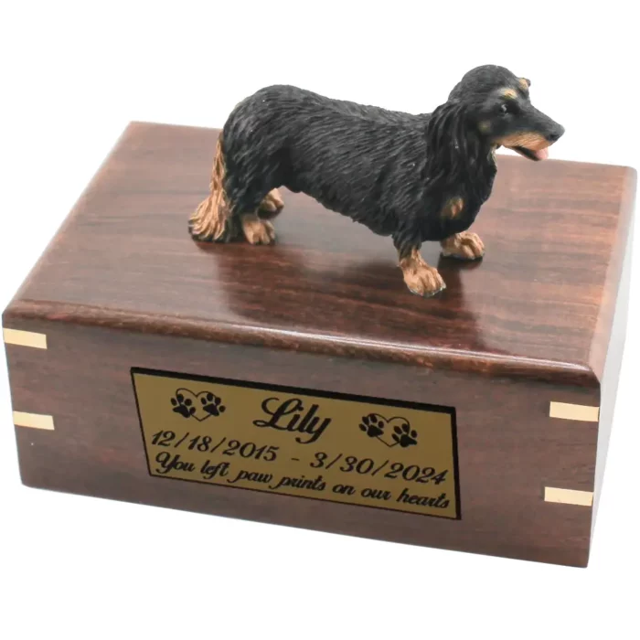 Black and tan longhaired dachshund dog figurine on wood cremation urn, engraved plate