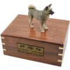 Gray akita dog figurine on wood cremation urn, engraved plate