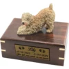 Soft coated wheaten dog figurine on wood cremation urn, engraved plate