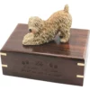 Soft coated wheaten dog figurine on wood cremation urn, engraved wood