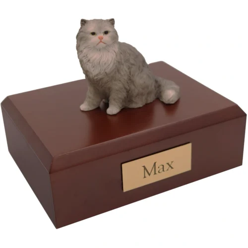 Sitting gray white persian cat figurine on wood memorial cremation urn