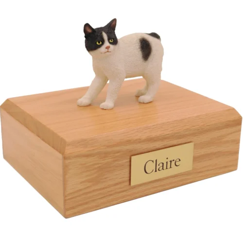 Standing white and black manx cat figurine on wood cremation urn