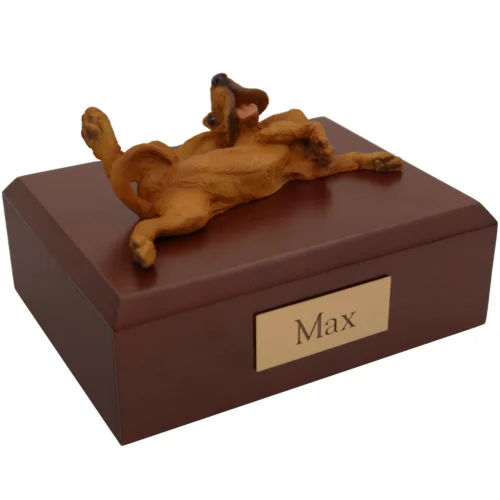 Laying bloodhound dog figurine on wood memorial cremation urn