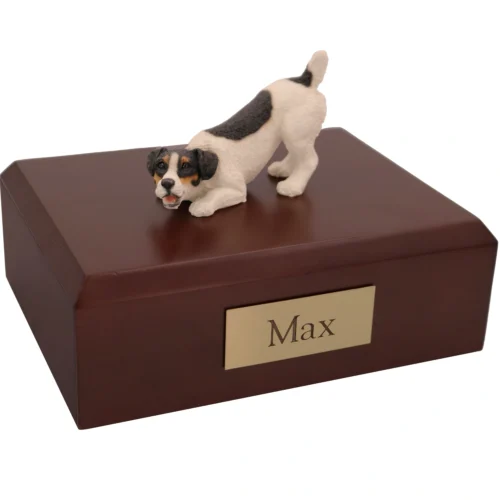 Playful black white tricolor jack russell terrier dog figurine on wood memorial cremation urn