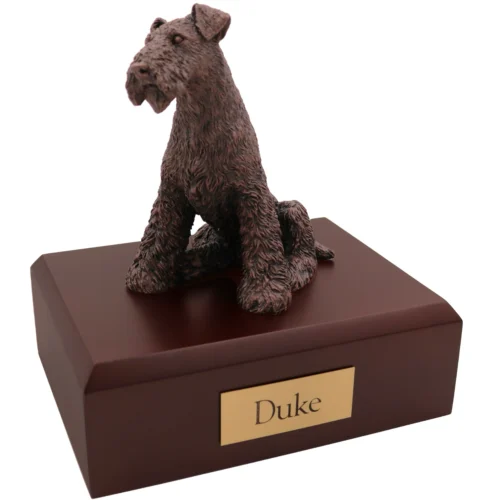 Sitting airedale terrier bronze look dog figurine on wood cremation urn