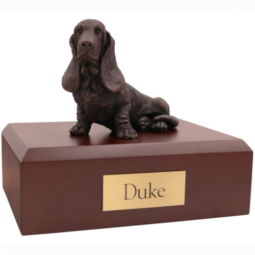 Sitting basset hound bronze look dog figurine on wood cremation urn