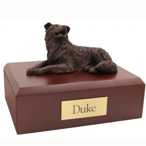 Laying border collie bronze look dog figurine on wood cremation urn