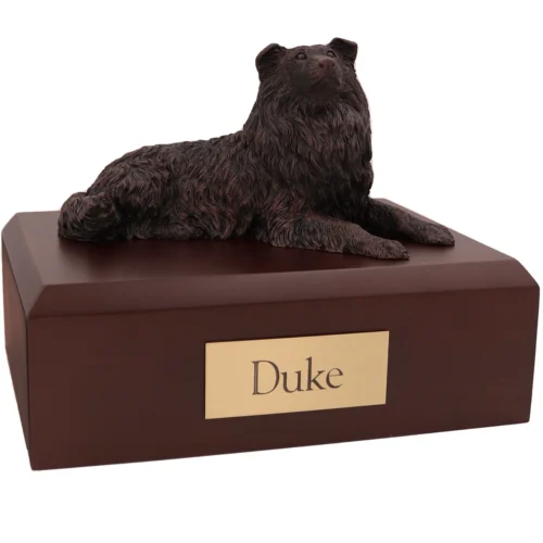 Laying collie bronze look dog figurine on wood cremation urn