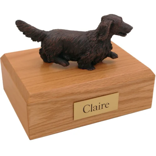 Walking long-haired dachshund bronze look dog figurine on wood cremation urn