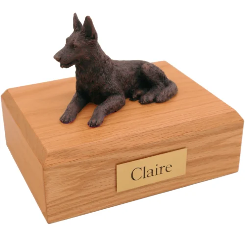 Laying german shepherd bronze look dog figurine on wood cremation urn