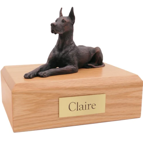Laying great dane ears up bronze look dog figurine on wood cremation urn