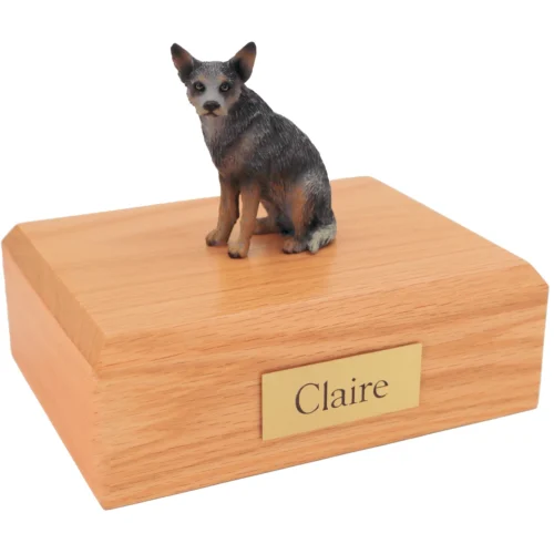 Sitting blue gray australian cattle dog figurine on wood cremation urn