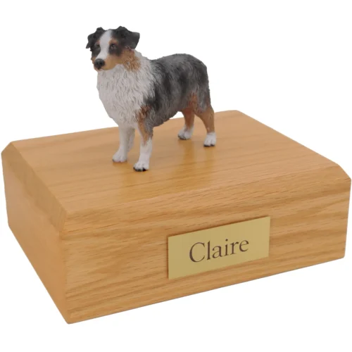 Standing docked blue australian shepherd dog figurine on wood cremation urn