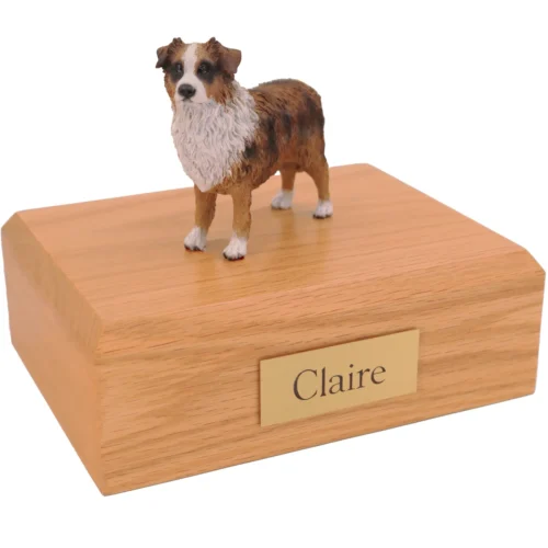 Standing brown australian shepherd dog figurine on wood cremation urn