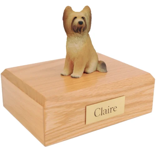 Sitting briard dog figurine on wood cremation urn