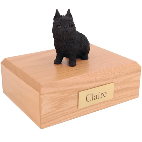 sitting black brussels griffon dog figurine on wood cremation urn