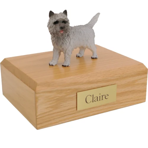 Standing gray cairn terrier dog figurine on wood cremation urn