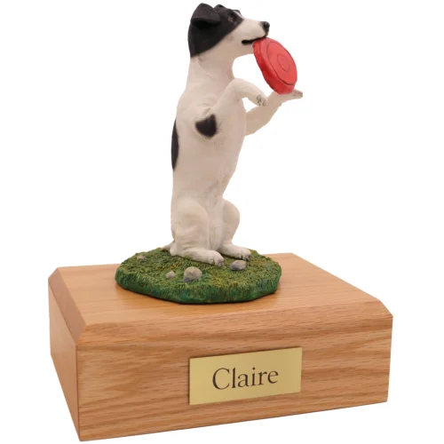 Black and white Jack Russell Terrier with frisbee dog figurine on wood memorial pet cremation urn