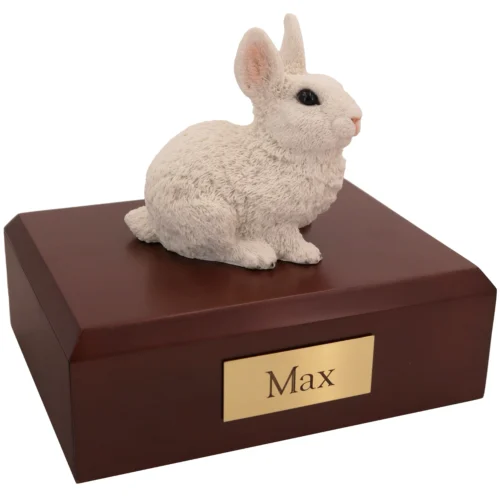 White rabbit figurine on wood cremation urn