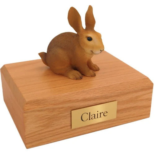 Brown rabbit figurine on wood cremation urn