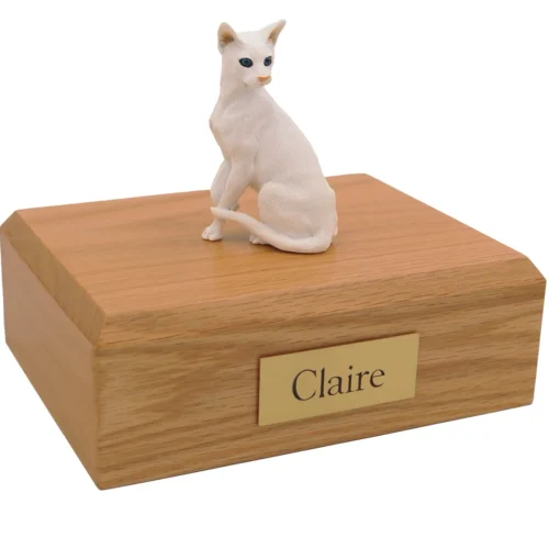 Sitting white oriental shorthair cat figurine on wood cremation urn