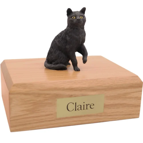 Sitting black shorthaired cat figurine on wood cremation urn