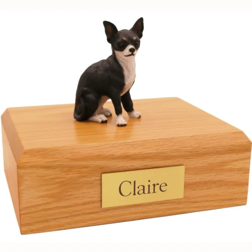 Sitting black and white Chihuahua dog figurine on wood cremation urn