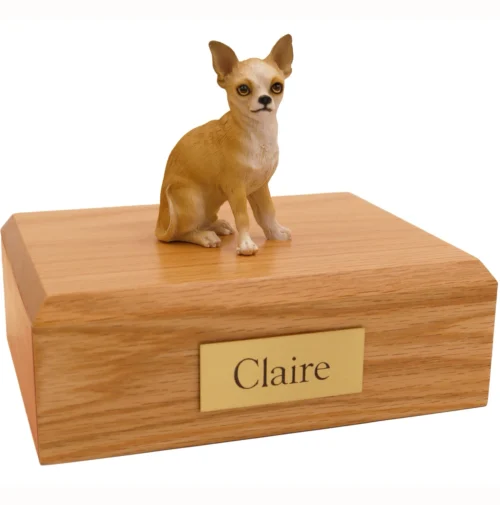 Sitting white and tan Chihuahua dog figurine on wood cremation urn