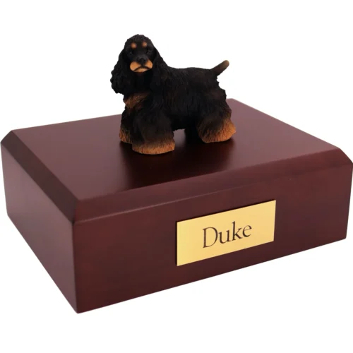 Standing black and brown Cocker Spaniel dog figurine on wood cremation urn