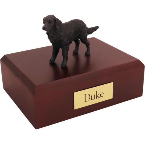 Standing flat coated retriever dog figurine on wood cremation urn
