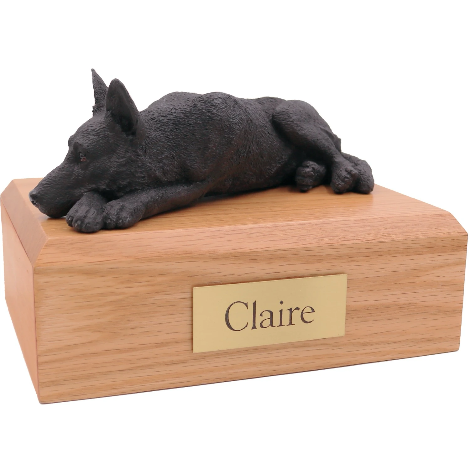 Laying black German Shepherd dog figurine on wood cremation urn