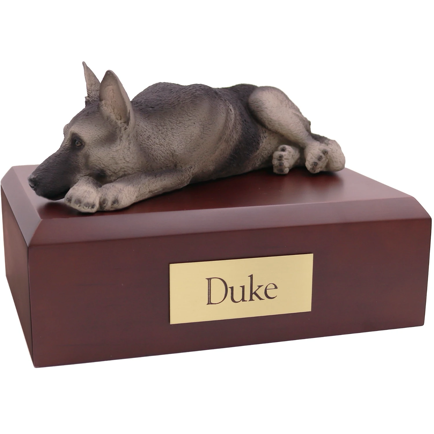 Laying black and silver German Shepherd dog figurine on wood cremation urn