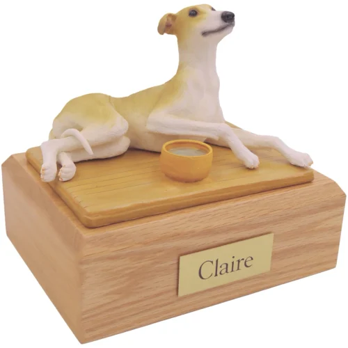 Laying tan Greyhound dog figurine on wood cremation urn