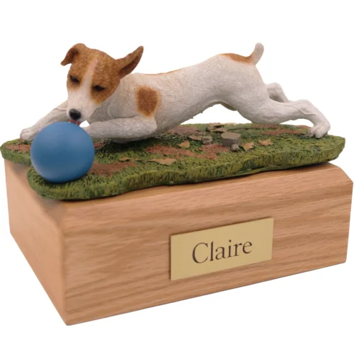 Brown and white Jack Russell Terrier with ball dog figurine on wood cremation urn
