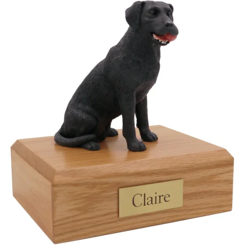 Black Labrador Retriever with ball dog figurine on wood cremation urn