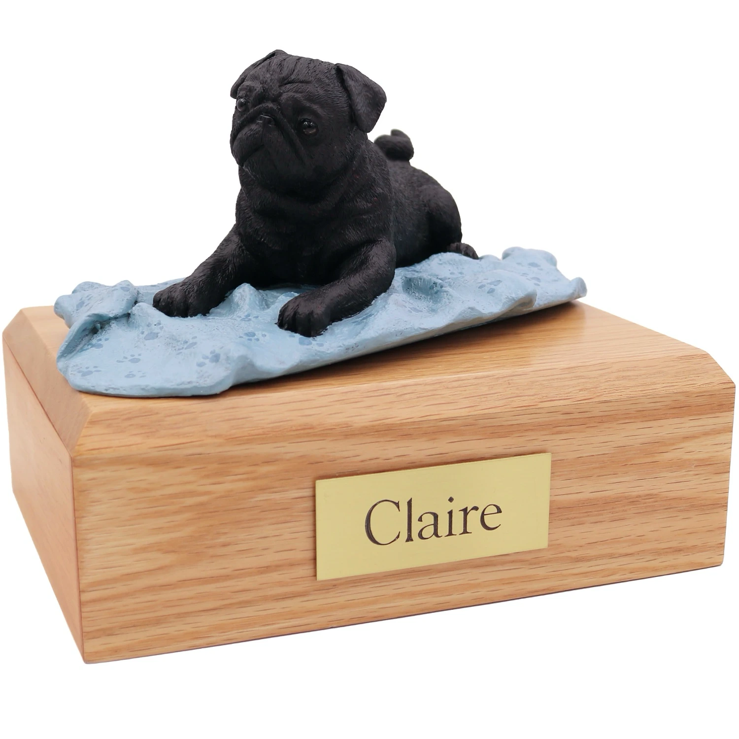 Laying black Pug on blanker dog figurine on wood cremation urn