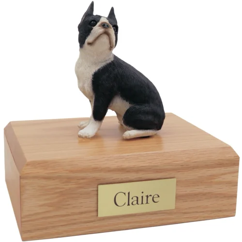 Black and white sitting Boston Terrier dog figurine on wood cremation urn