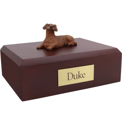 Laying red Dachshund dog figurine on wood cremation urn