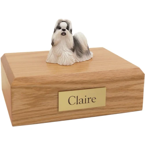 Black and white Shih Tzu dog figurine on wood cremation urn