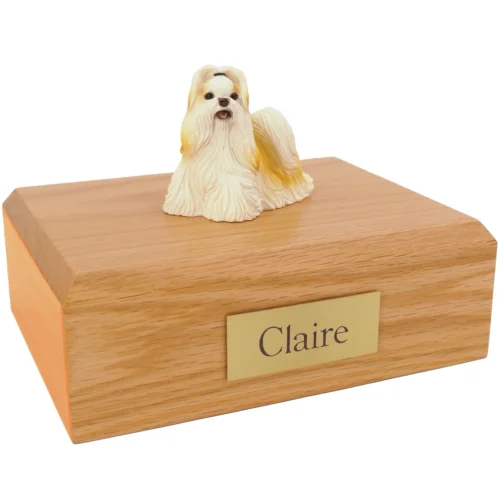 Gold and white Shih Tzu dog figurine on wood cremation urn