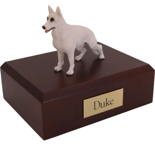 Standing white German Shepherd dog figurine on wood cremation urn