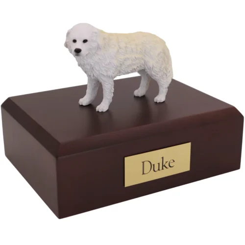 Standing white Great Pyrenees dog figurine on wood cremation urn