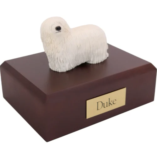 Standing white Komondor dog figurine on wood cremation urn
