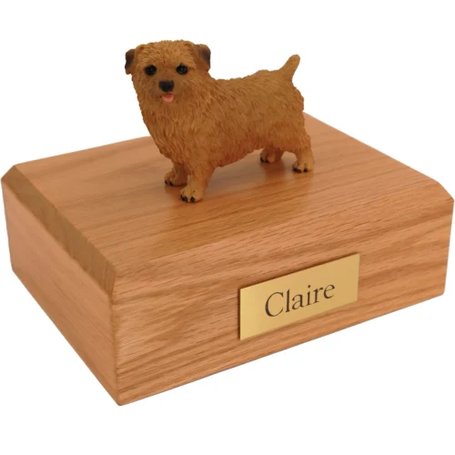 Standing red norfolk terrier dog figurine on wood cremation urn