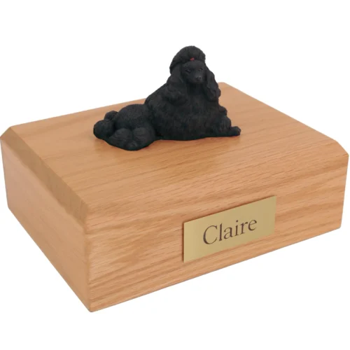Laying Chocolate Poodle dog figurine on wood cremation urn
