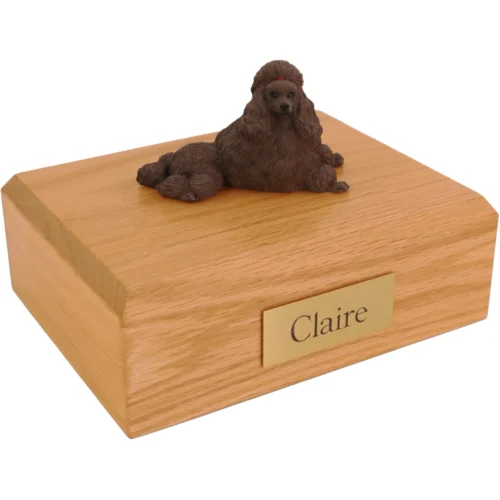 Laying Chocolate Poodle dog figurine on wood cremation urn